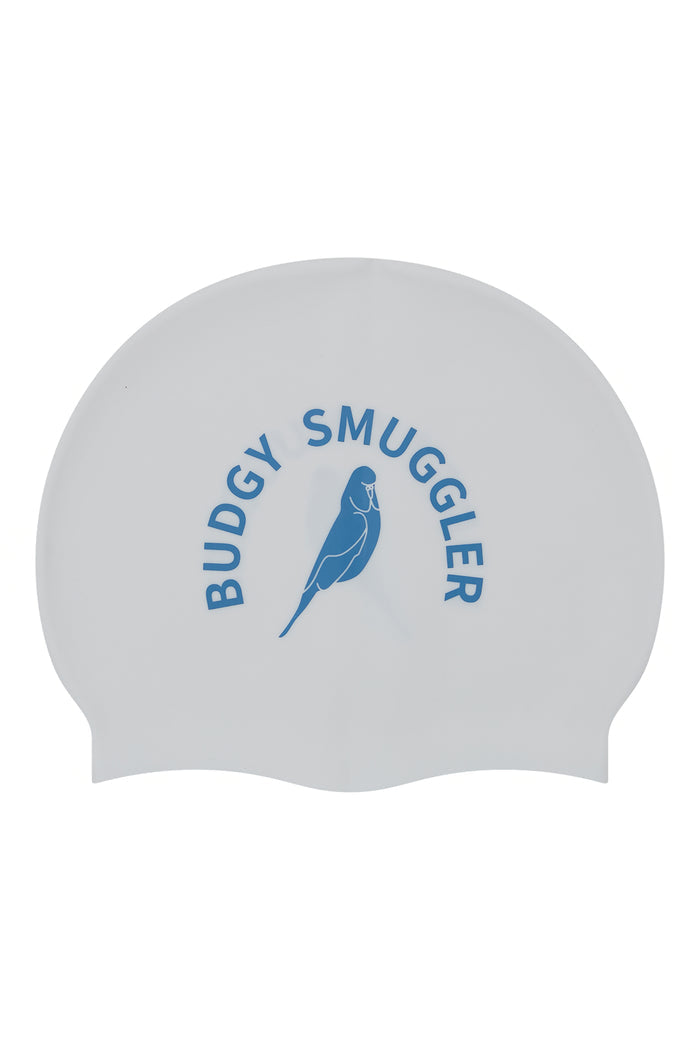 A white silicone swim cap featuring a blue printed logo with the text 'BUDGY SMUGGLER' and a bird illustration, shown against a plain white background.
