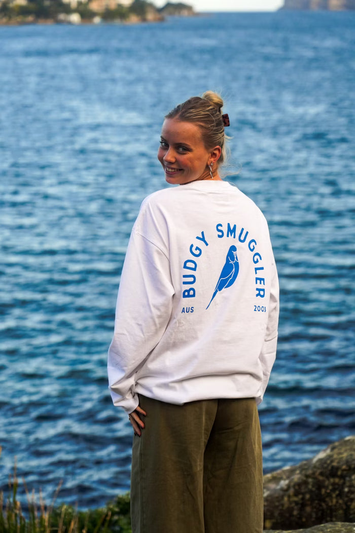 Person wearing a 'Budgy Smuggler' sweatshirt by the water